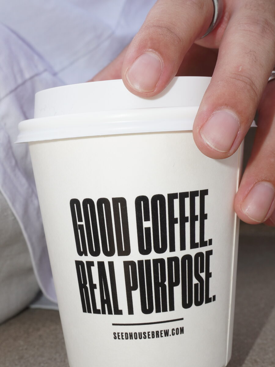 A Seed House cup reading Good Coffee. Real Purpose.